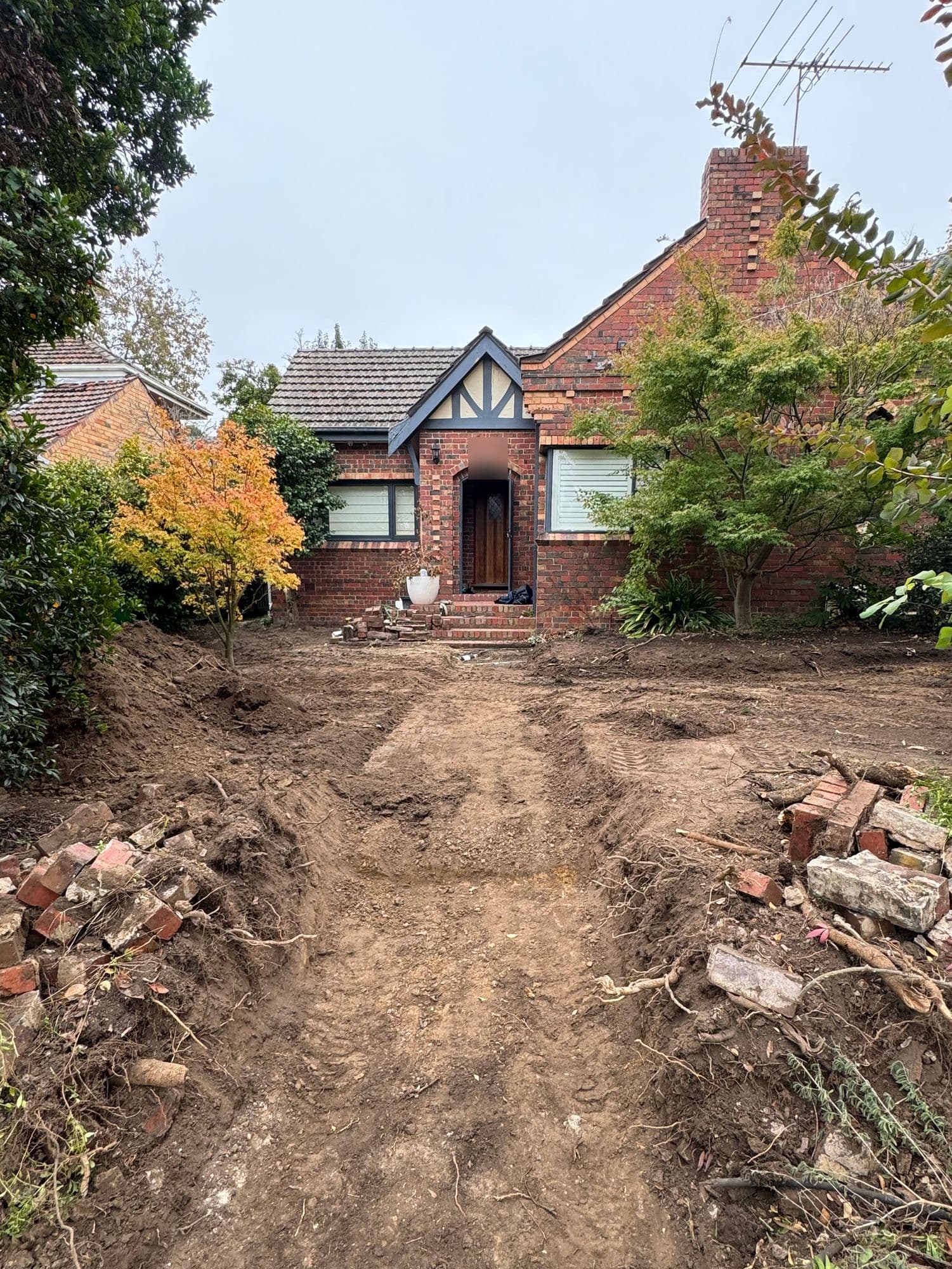 Before: a dug-out front yard and path ready for the new entry
