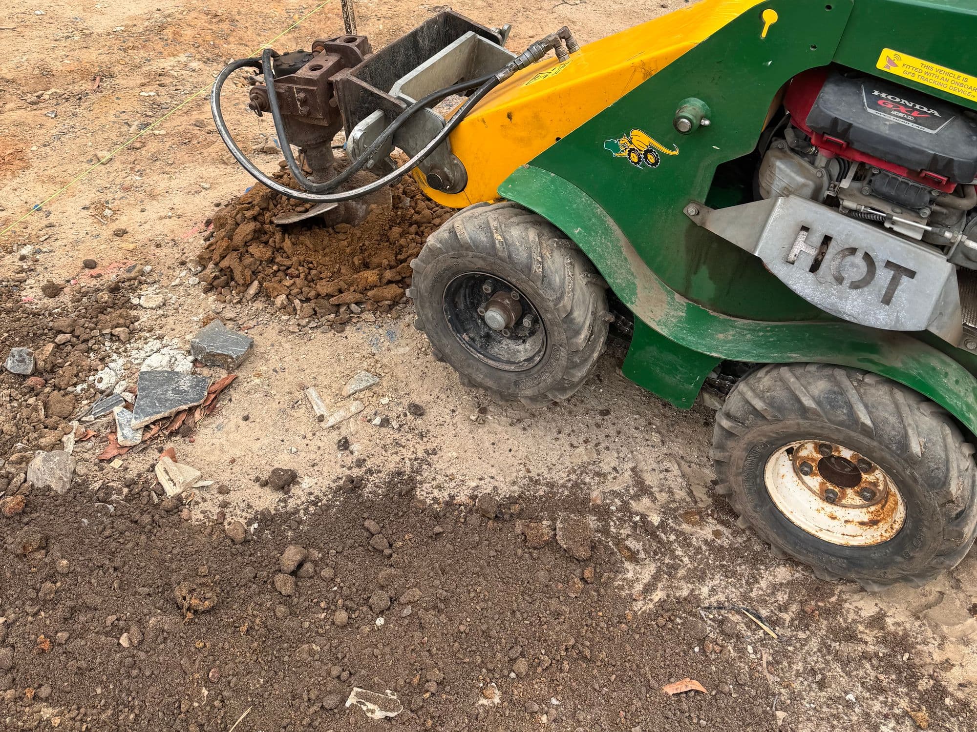 Drilling footings for a retaining wall at the entry of a new home