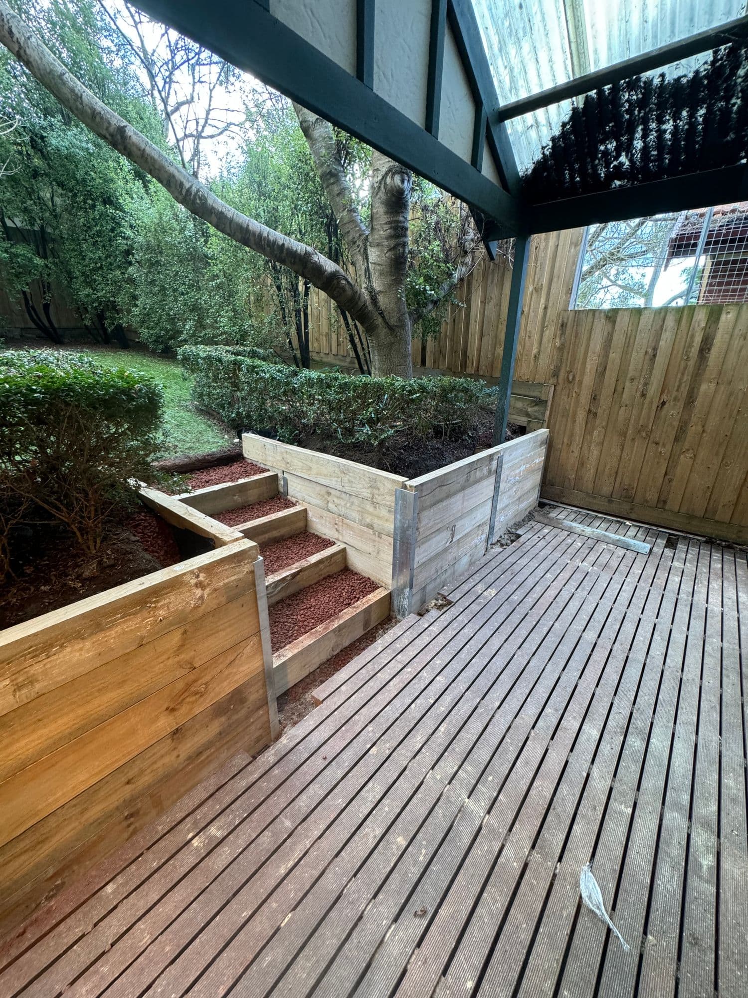 Timber sleeper retaining walls and steps built around an existing deck